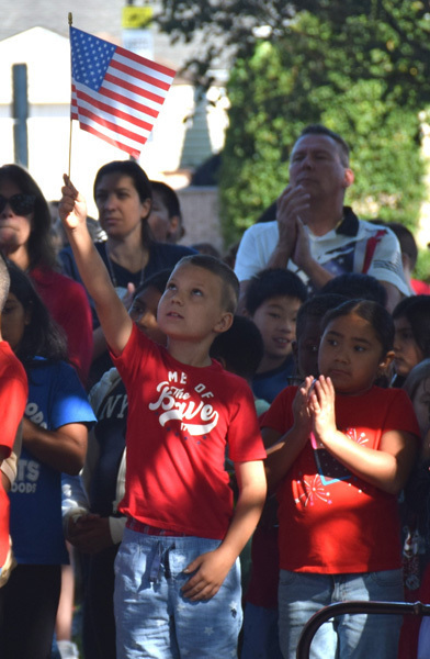 students waving a flag