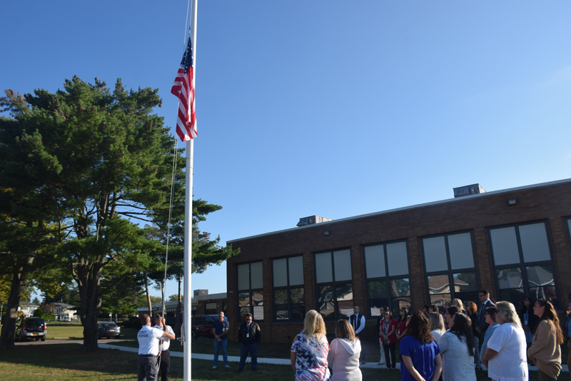 people outside by flag pole
