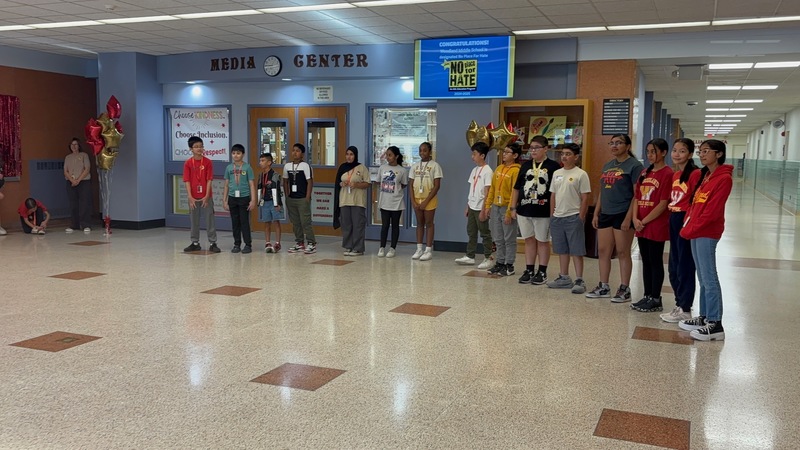 Woodland Students Standing in front of the banner during the ceremony
