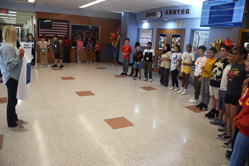 5-6: At the end of the ceremony, students and teachers recited the No Place for Hate pledge. 