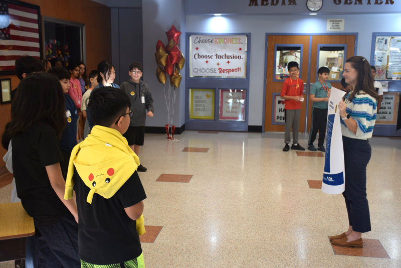 5-6: At the end of the ceremony, students and teachers recited the No Place for Hate pledge. 