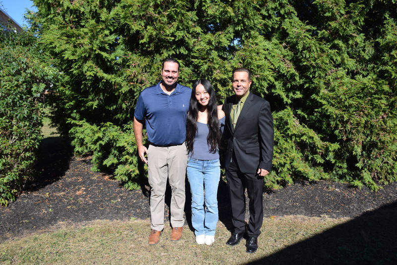 students outside in front of the trees