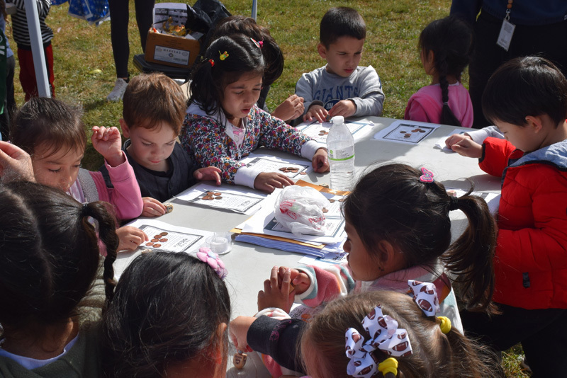 students at a table looking at papers on the table