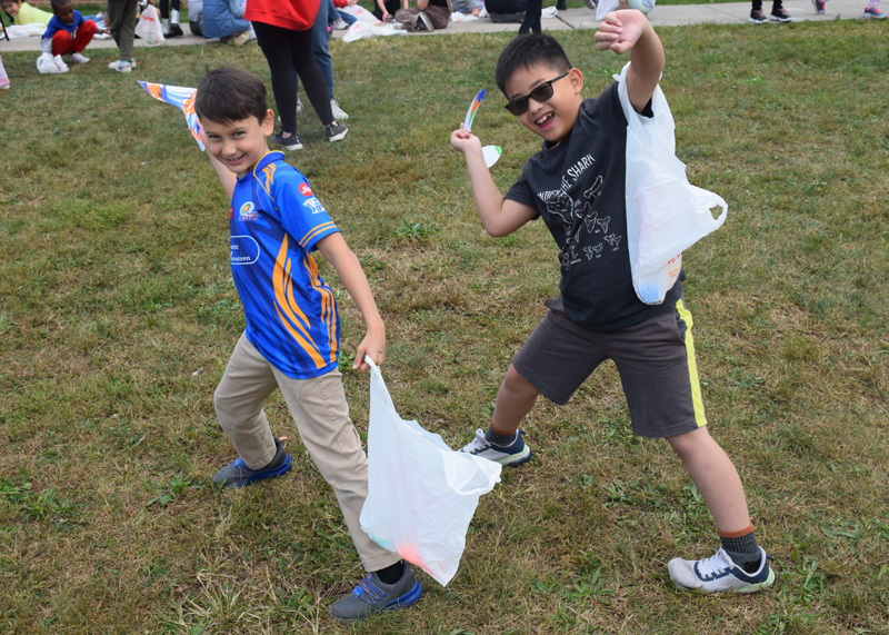 students with their white bags