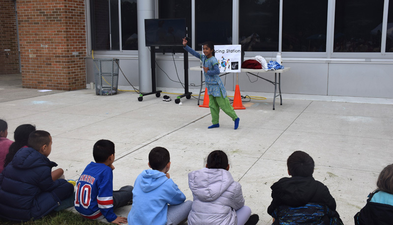 person dressed in cultural clothing doing a demonstration