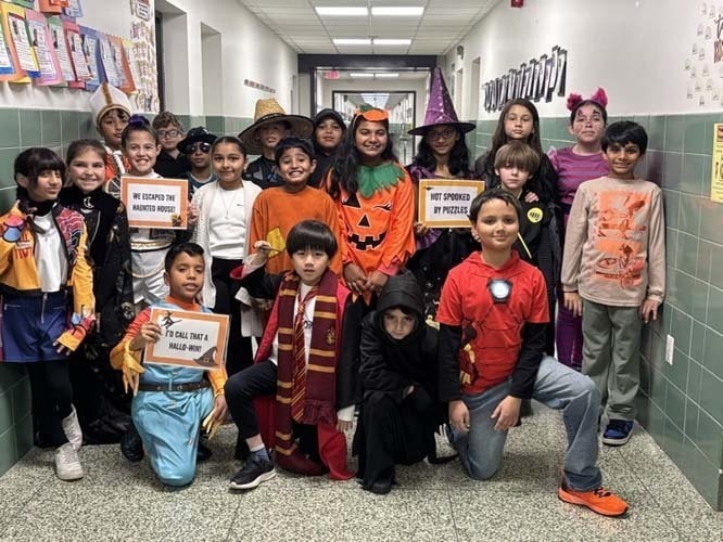 SStudents marching on the street while wearing Halloween costumes.