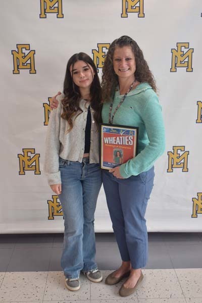 Photo of student and faculty member holding Breakfast of Champions plaque.