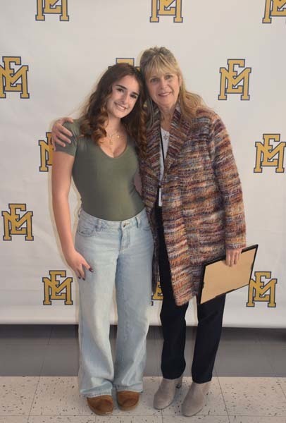 Photo of student and faculty member holding Breakfast of Champions plaque.