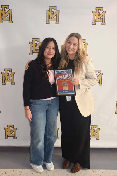 Photo of student and faculty member holding Breakfast of Champions plaque.