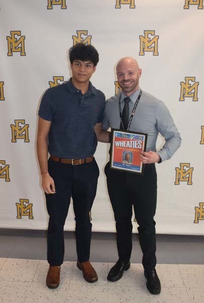 Photo of student and faculty member holding Breakfast of Champions plaque.