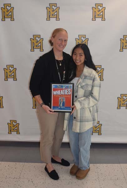 Photo of student and faculty member holding Breakfast of Champions plaque.
