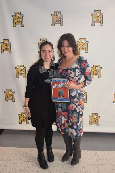 Photo of student and faculty member holding Breakfast of Champions plaque.