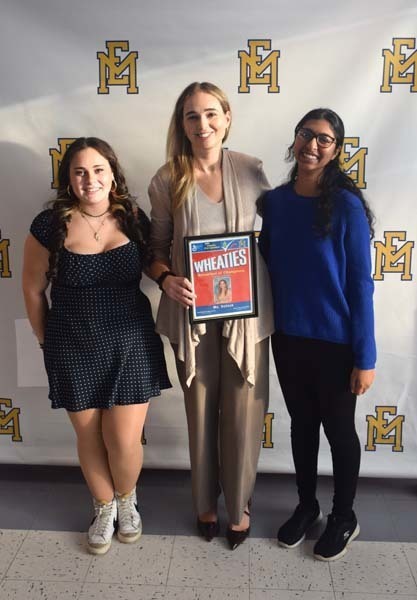 Photo of student and faculty member holding Breakfast of Champions plaque.