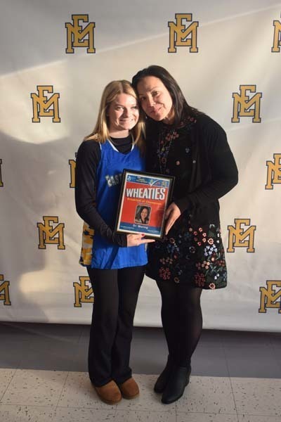 Photo of student and faculty member holding Breakfast of Champions plaque.
