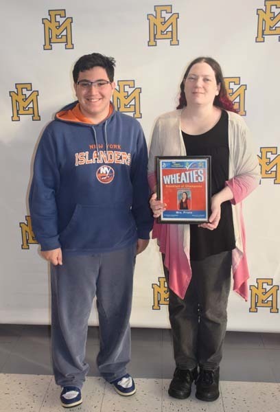 Photo of student and faculty member holding Breakfast of Champions plaque.