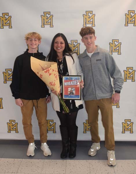 Photo of student and faculty member holding Breakfast of Champions plaque.