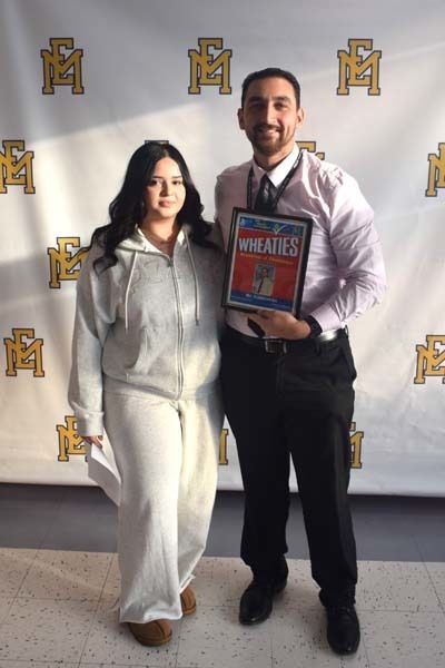 Photo of student and faculty member holding Breakfast of Champions plaque.