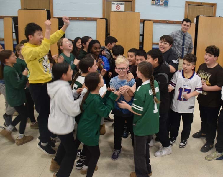 P Students cheered on their peers with signs and posters. 