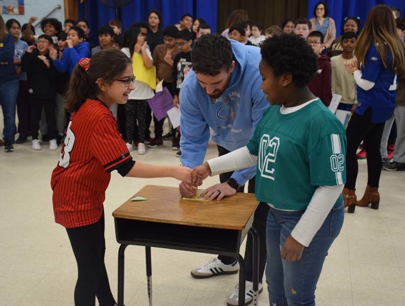 P Students cheered on their peers with signs and posters. 