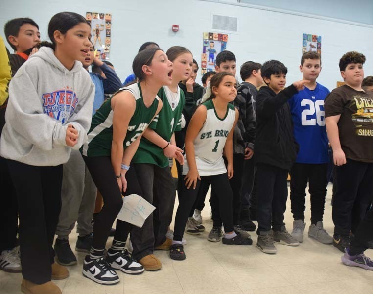 P Students cheered on their peers with signs and posters. 