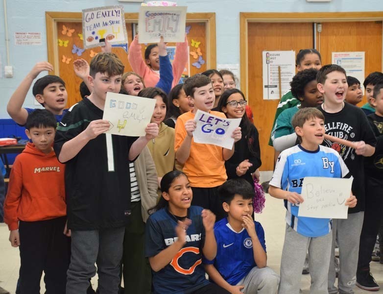 P Students cheered on their peers with signs and posters. 