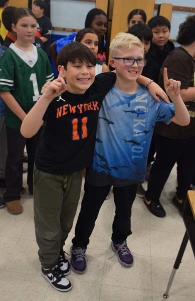 P Students cheered on their peers with signs and posters. 