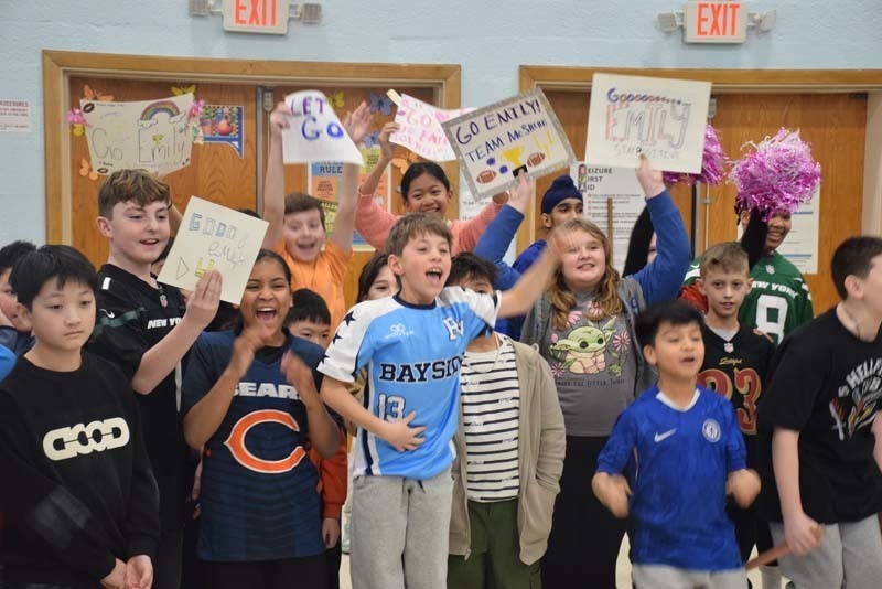 P Students cheered on their peers with signs and posters. 
