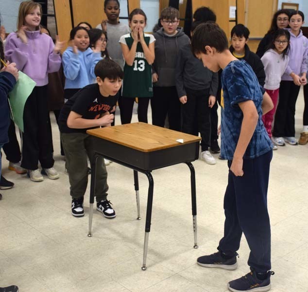 P Students cheered on their peers with signs and posters. 