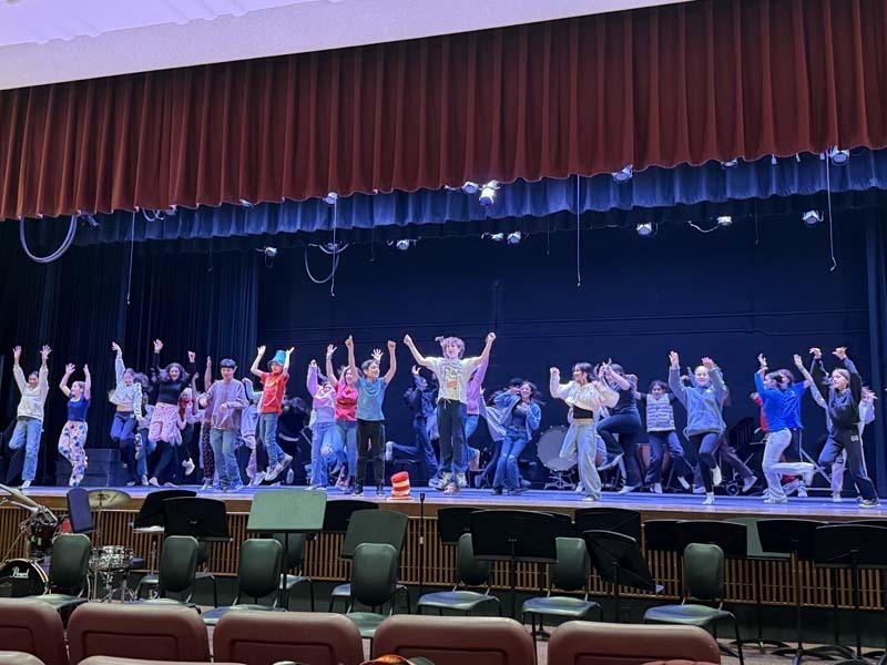 Students performing on stage.