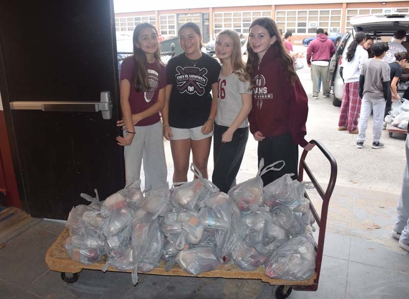 Students at W.T. Clarke Middle School in East Meadow partnered with Rock CAN Roll, Inc. to pack 750 lunches for individuals and families in need. 
