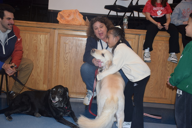  Parkway Principal Ms. Amelia Garcia and parents also greeted the dogs. 