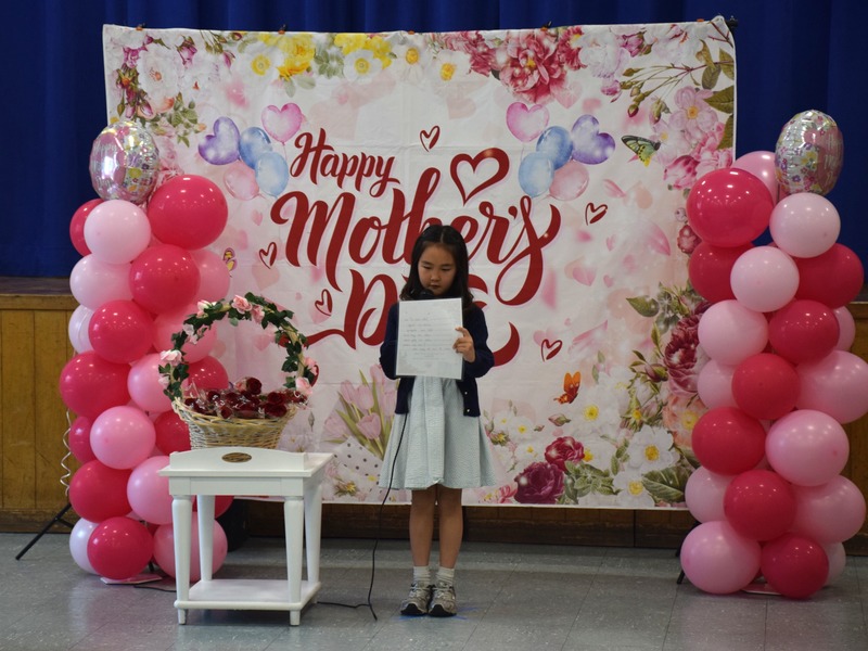 Second graders students presented their mothers with a rose and a hug after reading their poems.
