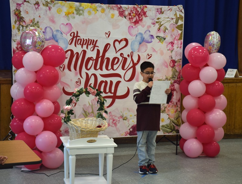 Second graders students presented their mothers with a rose and a hug after reading their poems.
