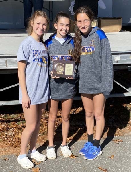 Three students holding an award and smiling Three students holding an award and smiling