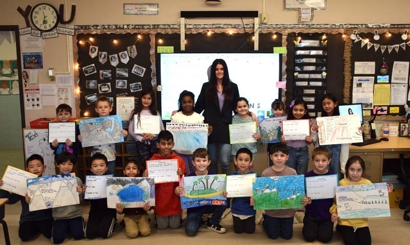 Students Holding Up Artwork