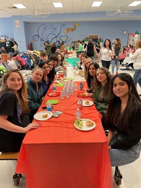 Students sitting at a table full of food