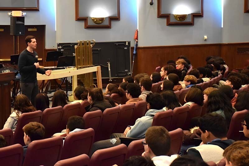 Stephen Hill speaking to students in an auditorium