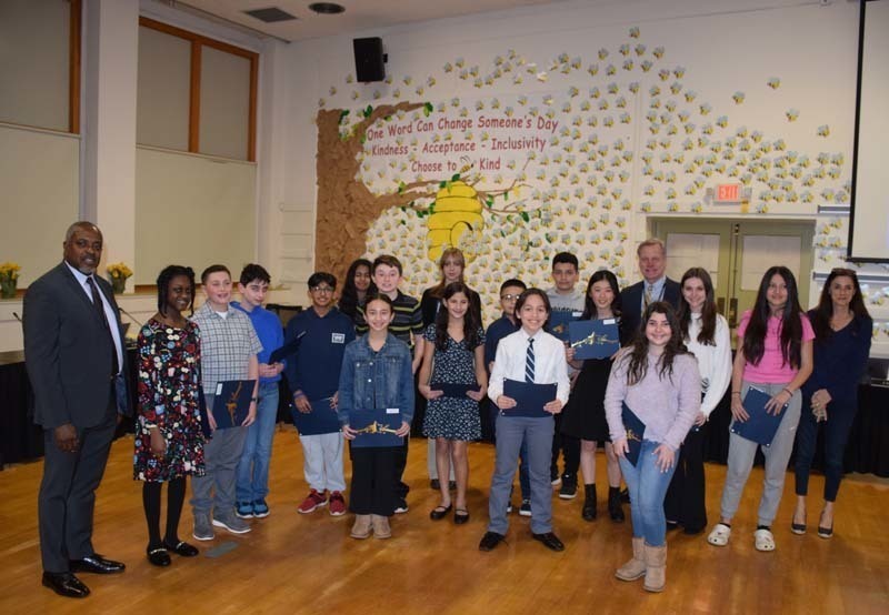 A large group of people standing together and smiling at the camera