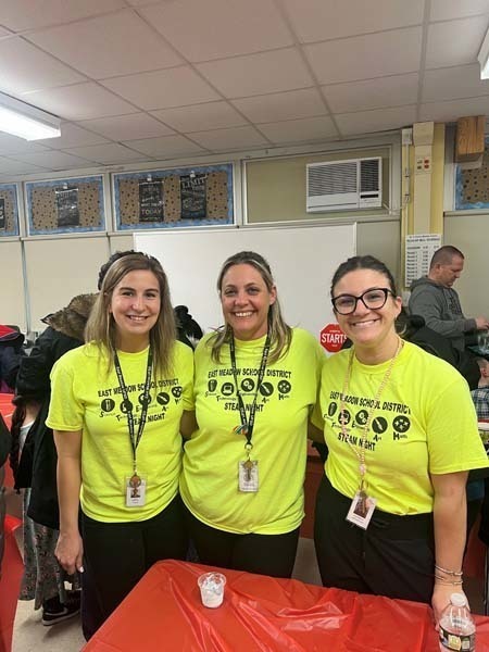 Three people with their arms around each other and smiling Three people with their arms around each other and smiling