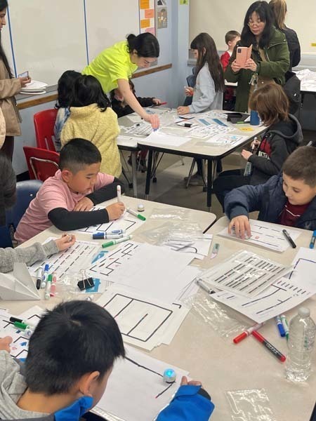 Students working on worksheets Students working on worksheets