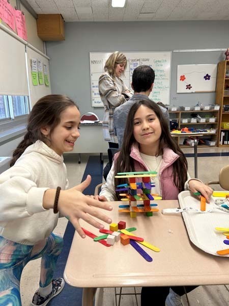 Students using stacking materials at a table Students using stacking materials at a table