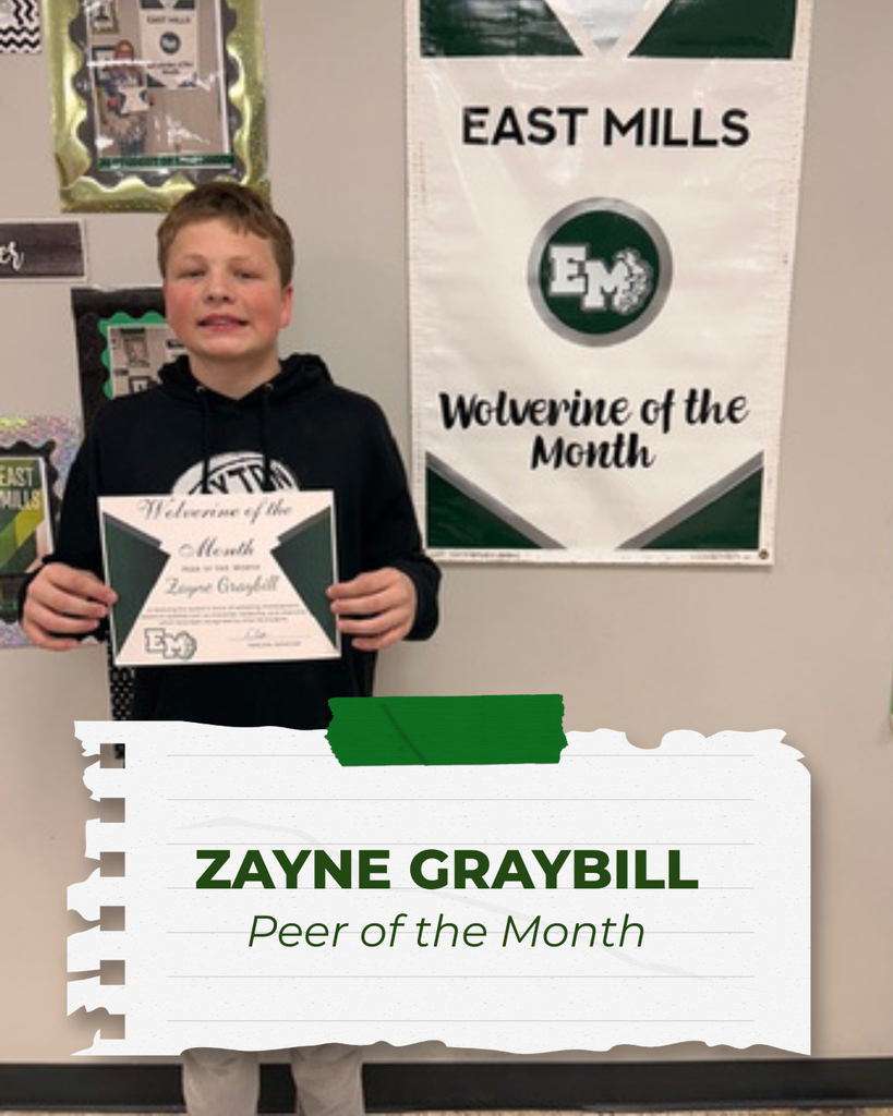 Zayne Graybill, Peer of the Month, standing and smiling while holding his certificate