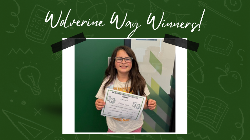 A young girl smiling and holding her Wolverine Way certificate