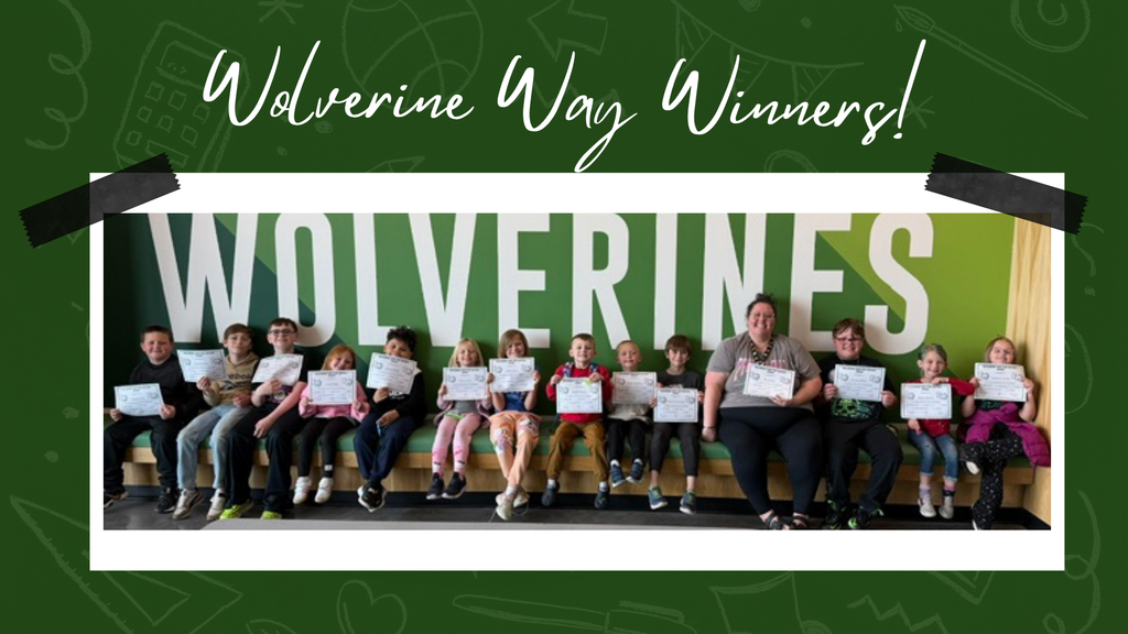 Elementary students proudly displaying their Wolverine Way certificates