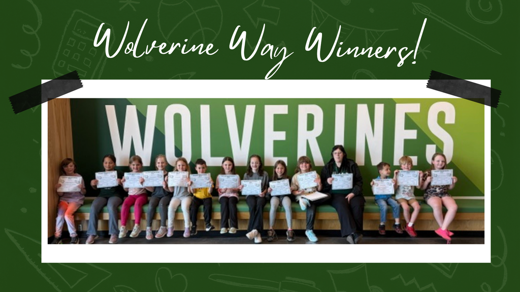 Elementary students proudly displaying their Wolverine Way certificates