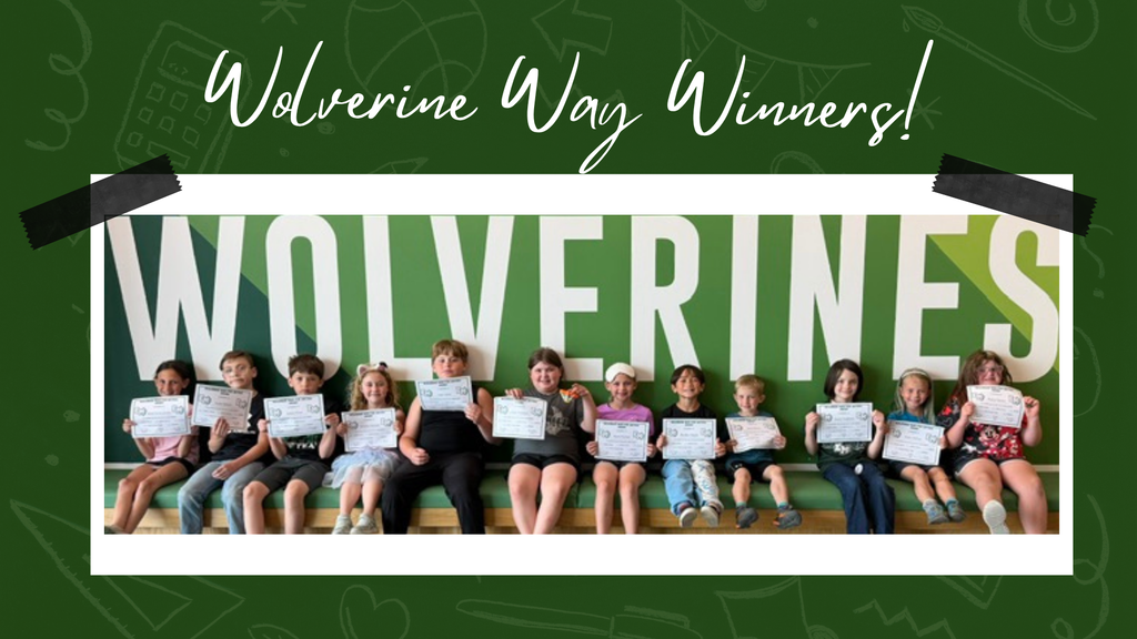 Elementary students proudly displaying their Wolverine Way certificates