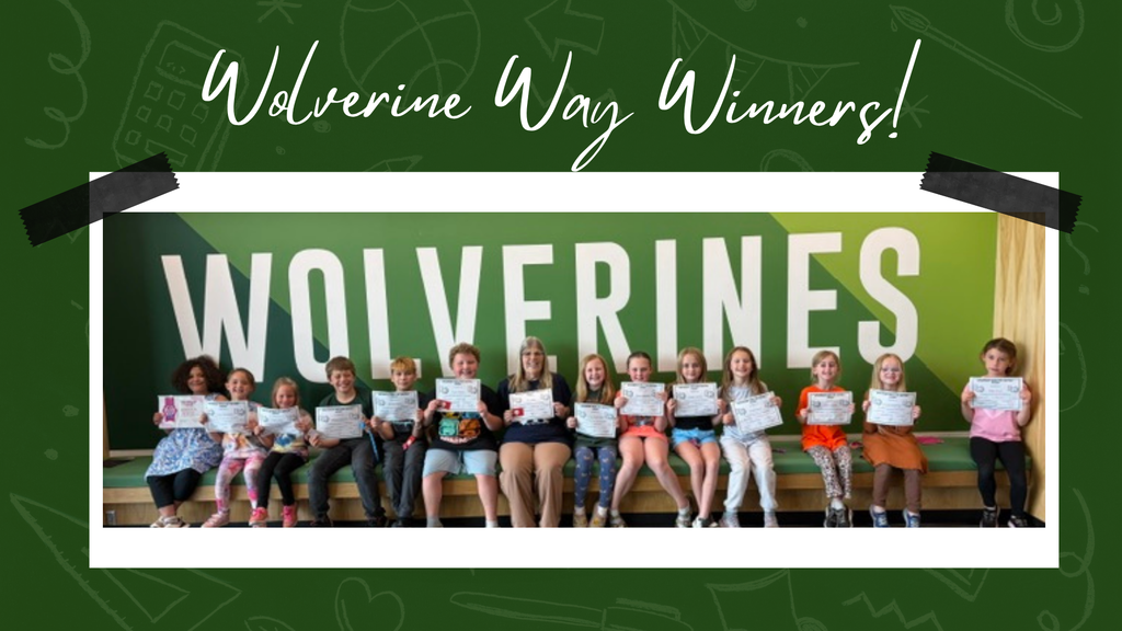 Elementary students proudly displaying their Wolverine Way certificates