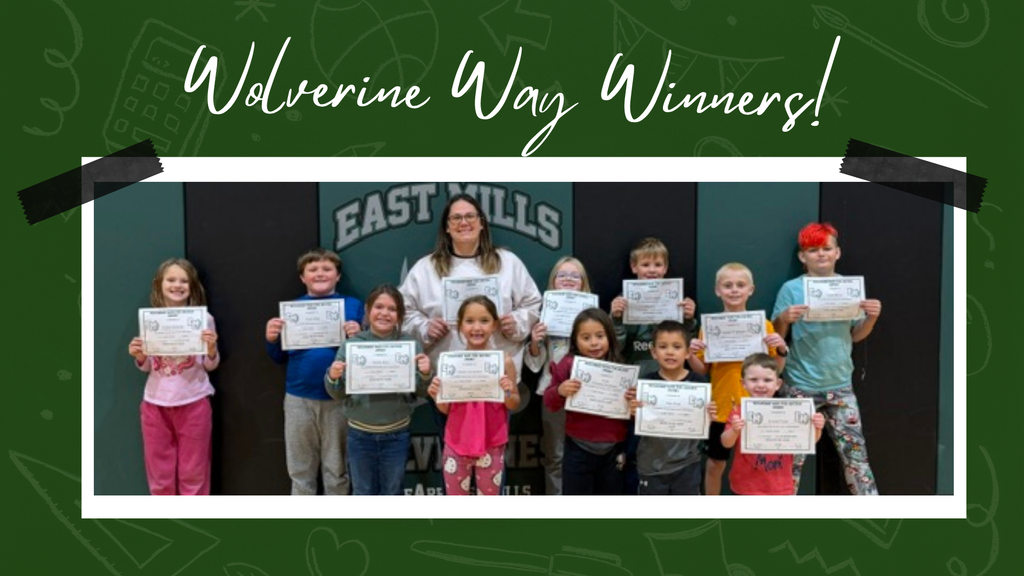 Students smiling in front of ab "East Mills" sign, holding their certificates