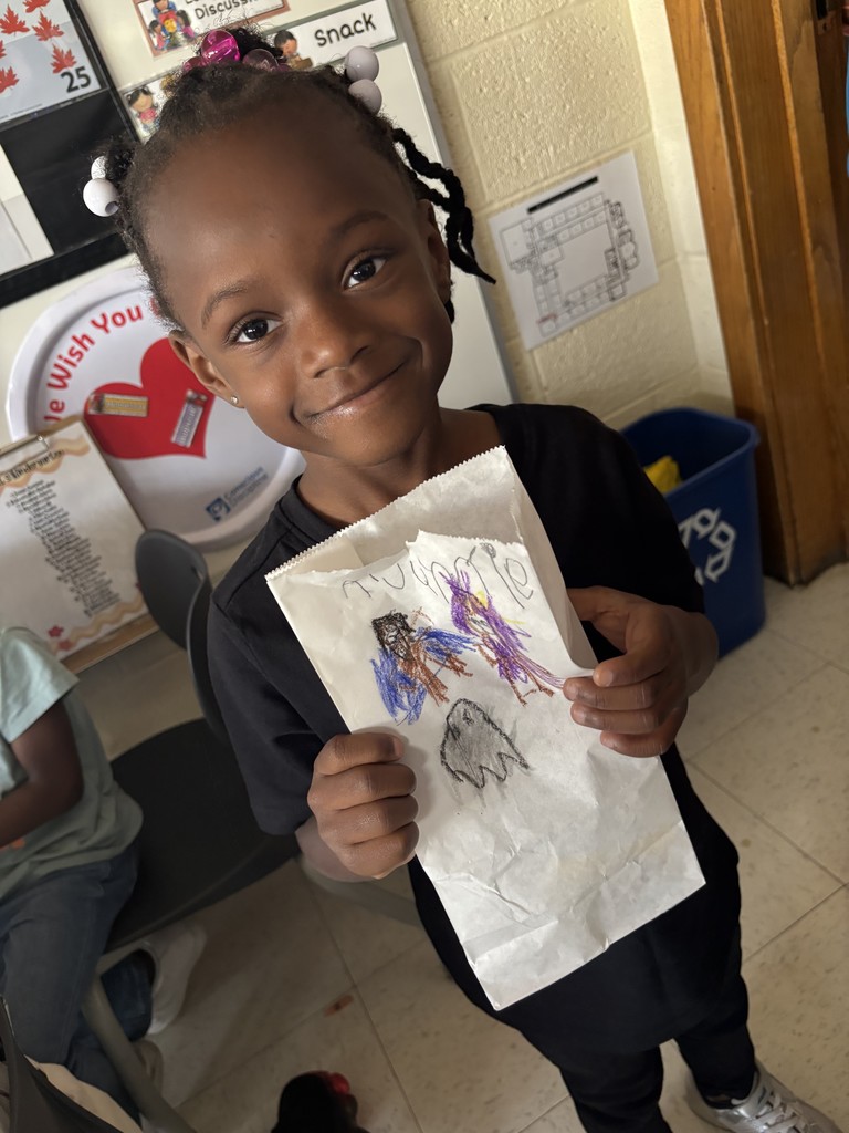 Kindergarten and first grade students decorate Halloween treat bags and practice trick-or-treating during a social lesson led by Speech-Language Pathologists.