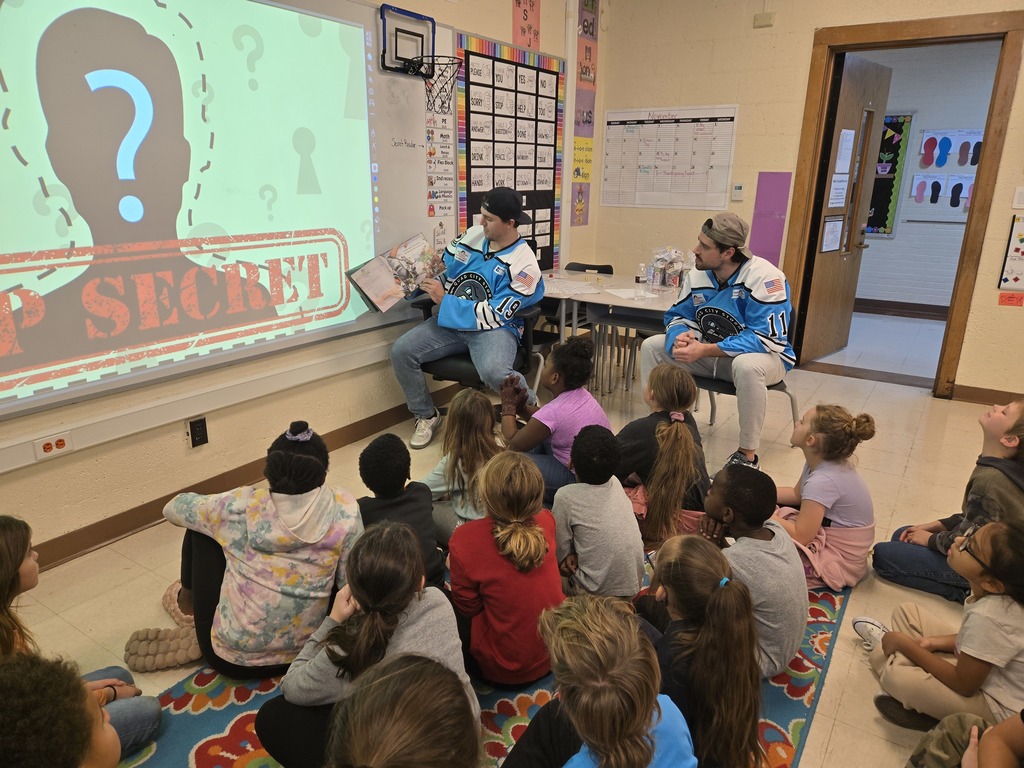 Players reading to students